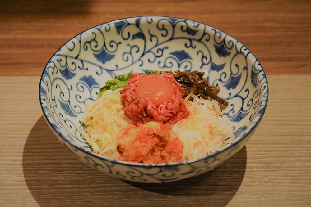 Yukhoe Bibimbap (Mixed rice with vegetables topped with seasoned raw beef)